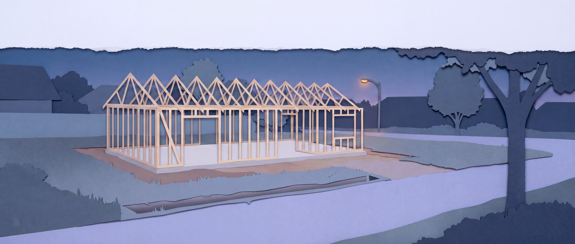 A half-built house at dusk, framed and roofed but unfinished, work stopped.